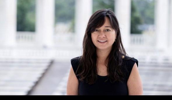 A woman in front of a set of steps.